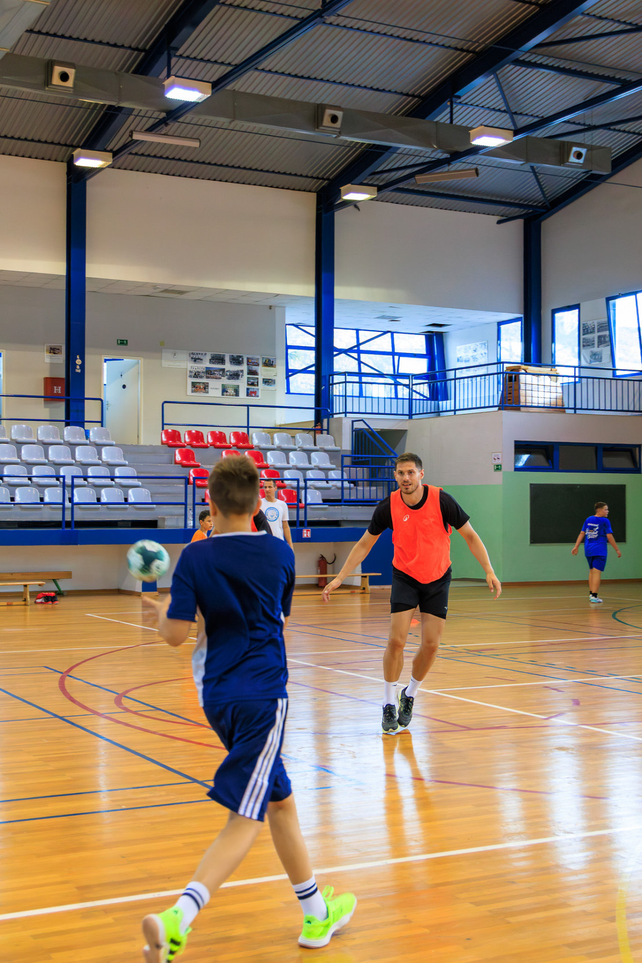 Professional player training with a young camper